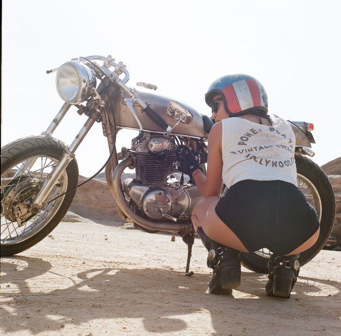 A playful frame from Girls on a motorcycle — online in Barcelona